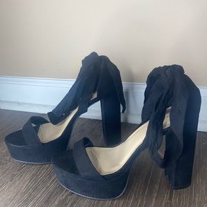 Black tie up high heels. Straps around the leg